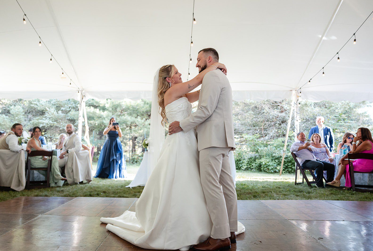 Bride and groom sharing their first dance under the tent, captured by New York wedding photographers from Original Weddings at a New York backyard wedding