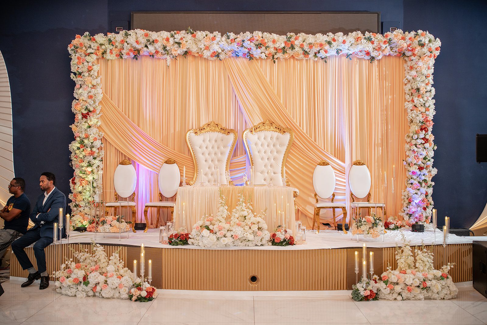 nuur-event-center-timeless-denver-henok-elshadaye-p001-06 Elegant reception stage with floral backdrop at Nuur Event Center