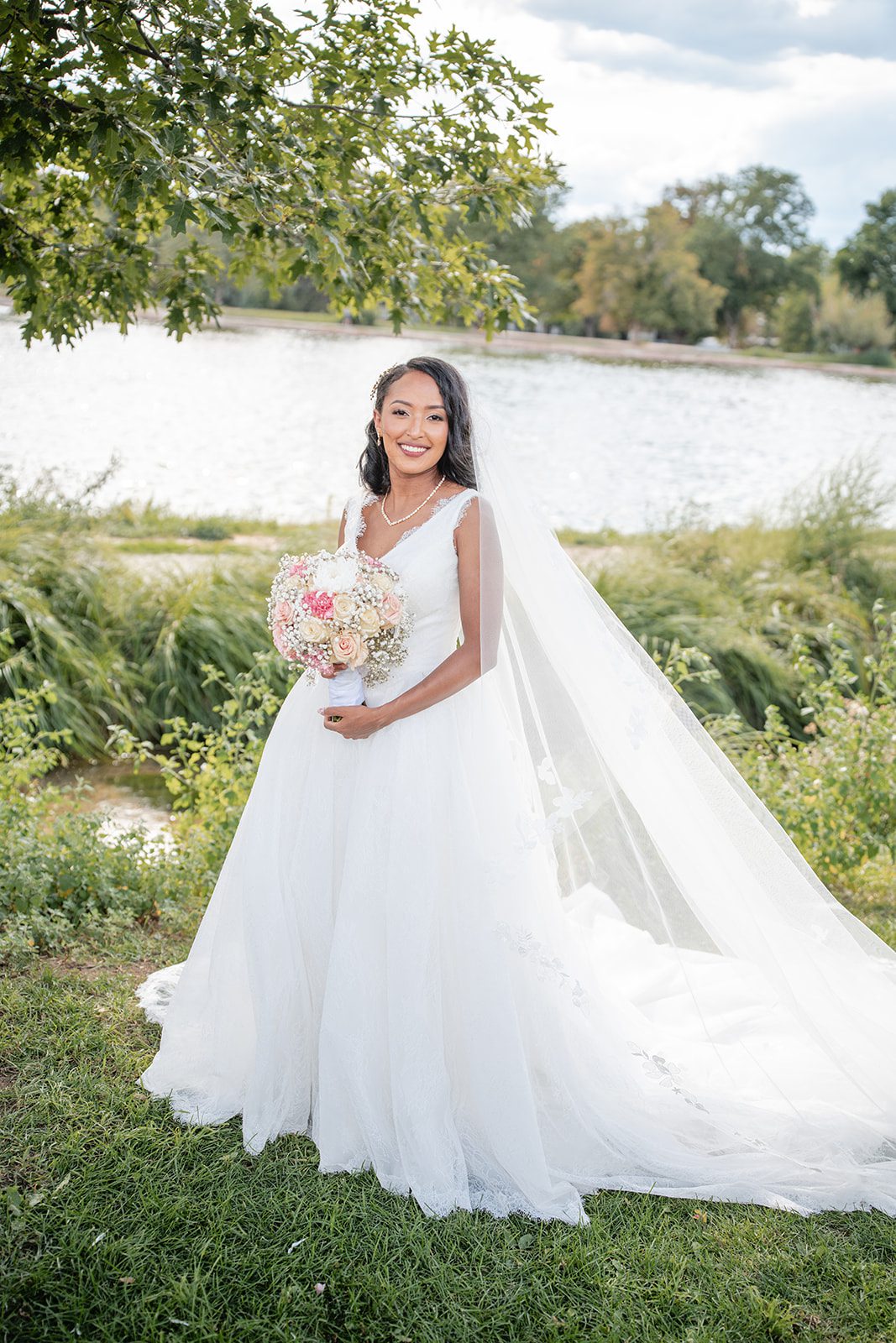 nuur-event-center-timeless-denver-henok-elshadaye-p008-08 Bride posing with her bouquet by the lake