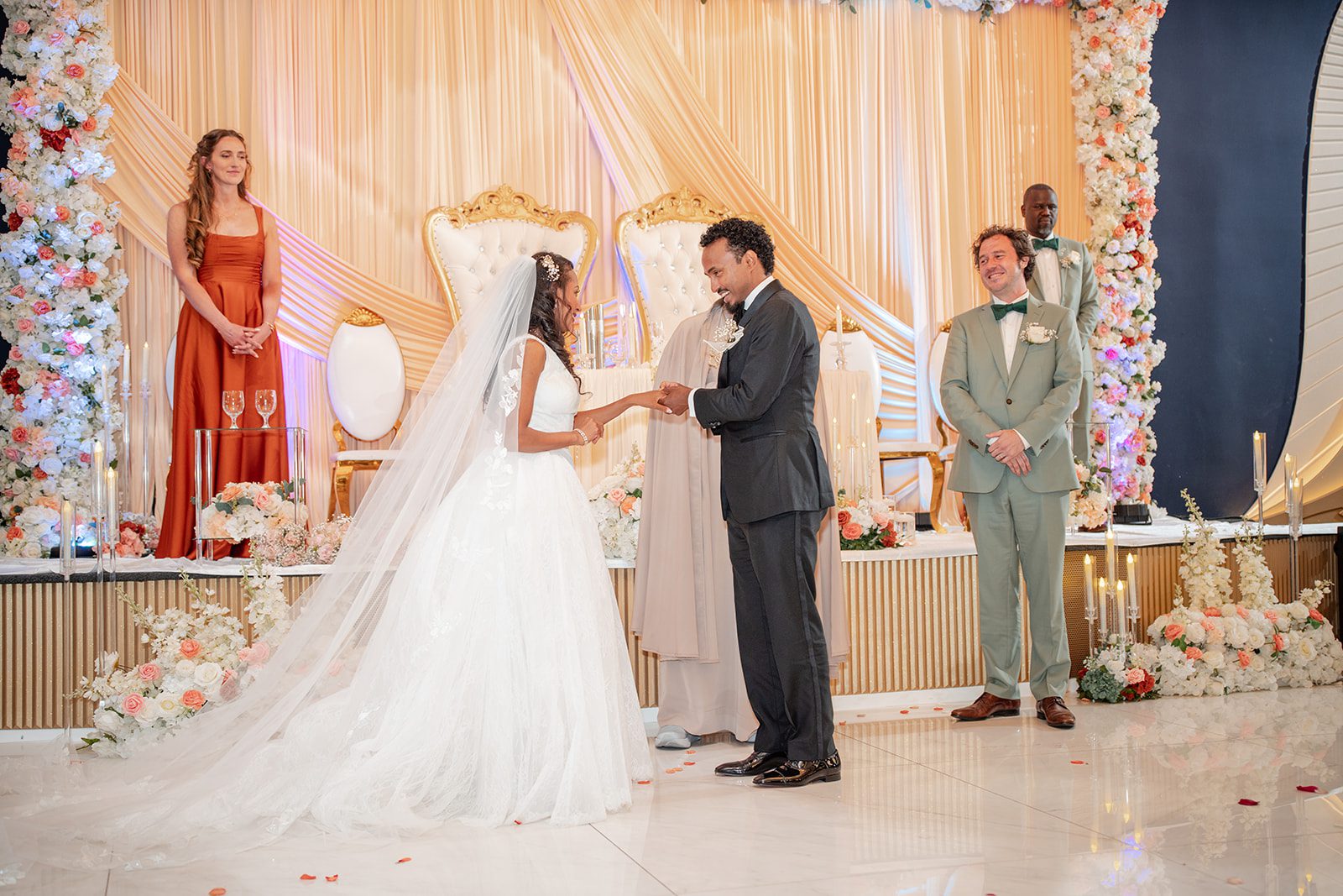 nuur-event-center-timeless-denver-henok-elshadaye-p011-12 Couple exchanging vows during the indoor ceremony at Nuur Event Center