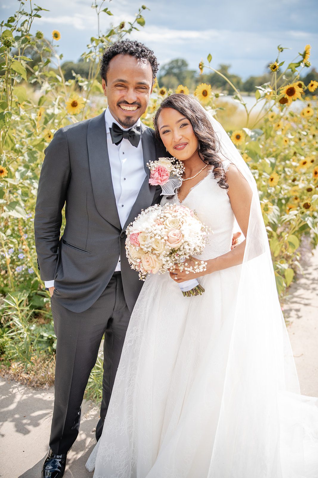 nuur-event-center-timeless-denver-henok-elshadaye-p016-13 Bride and groom smiling in the garden