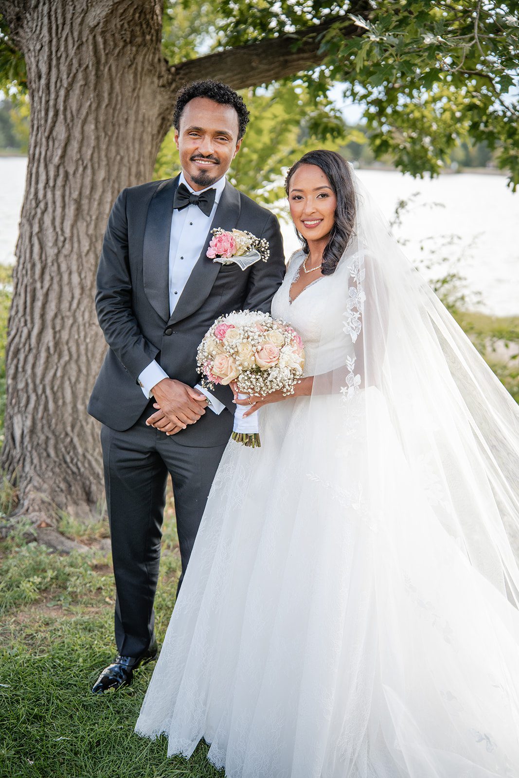 nuur-event-center-timeless-denver-henok-elshadaye-p020-31 Bride and groom under a large tree