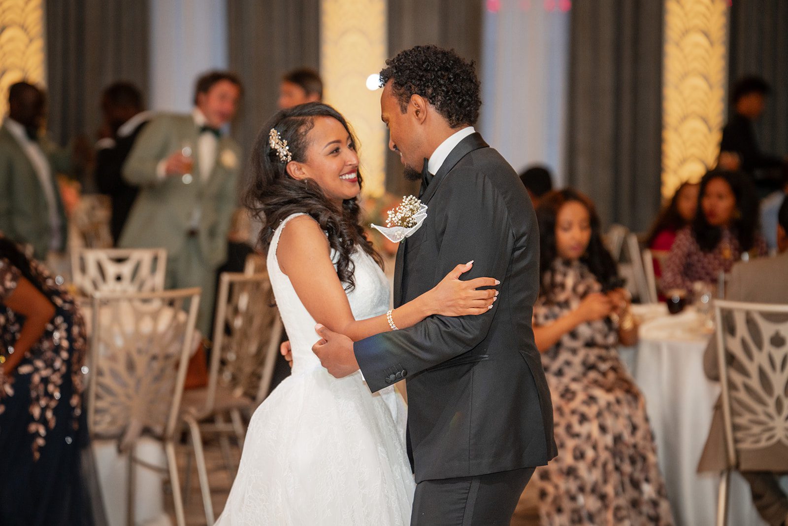 nuur-event-center-timeless-denver-henok-elshadaye-p035-17 Couple dancing under the chandeliers