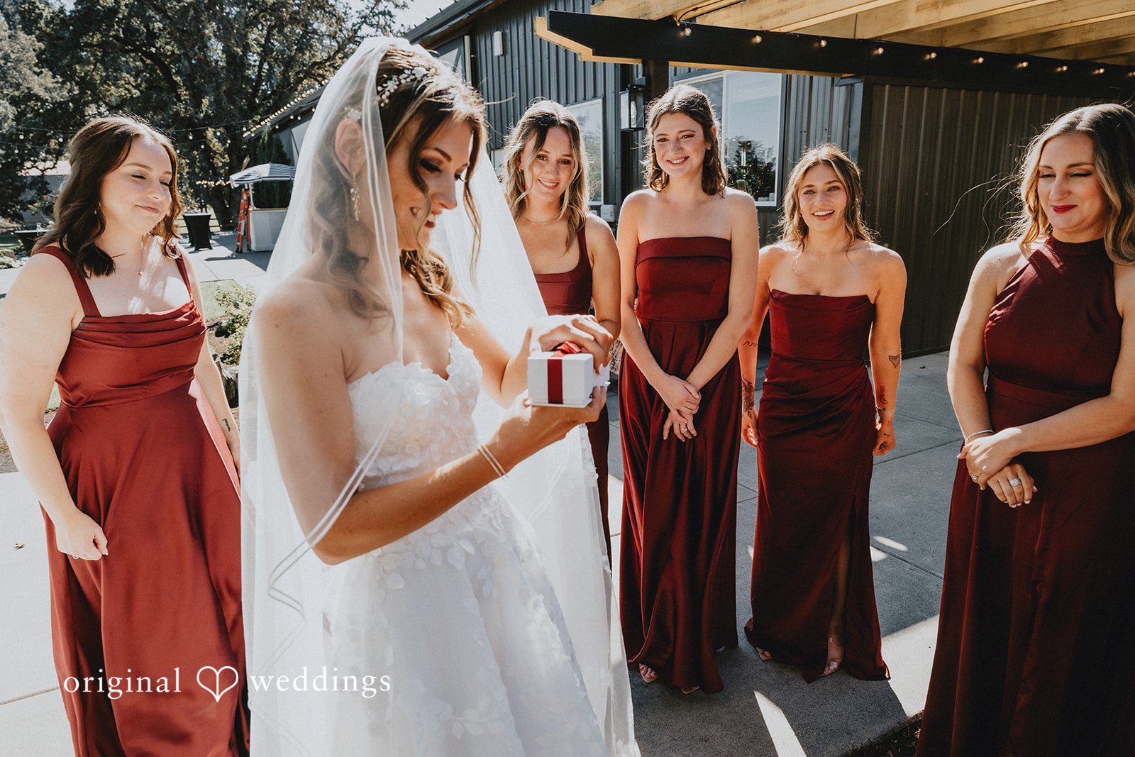 Bride getting ready with her bridesmaids in burgundy