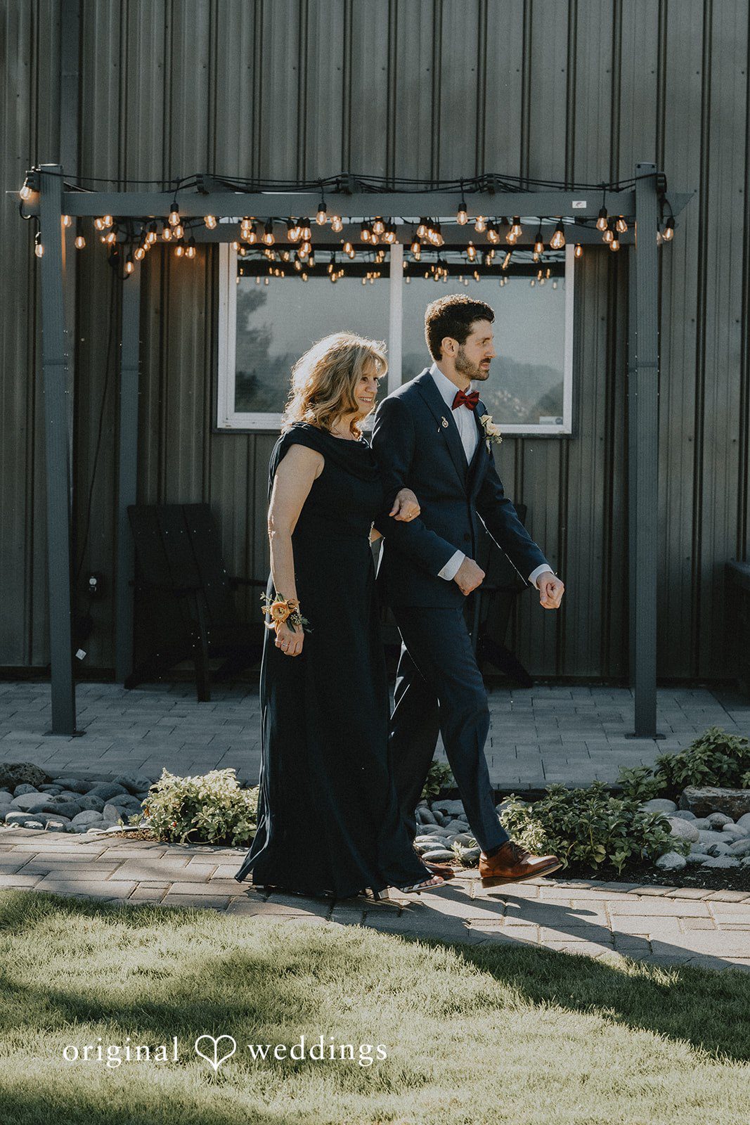 Groom getting ready by the barn doors at Oak & Hood