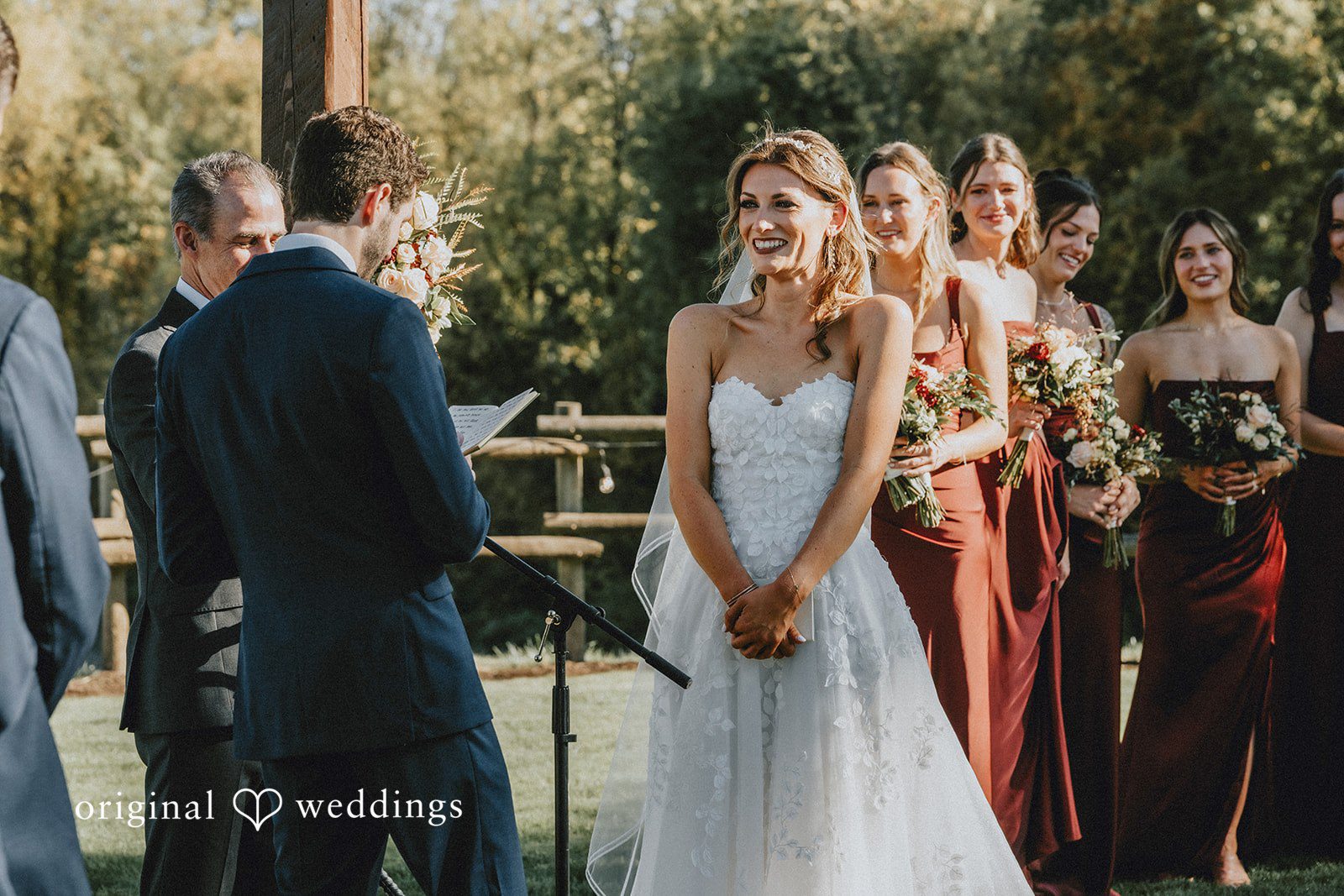 Bride laughing with her bridesmaids outside