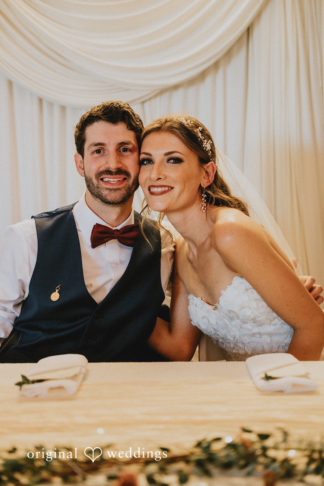 Groom smiling at the head table
