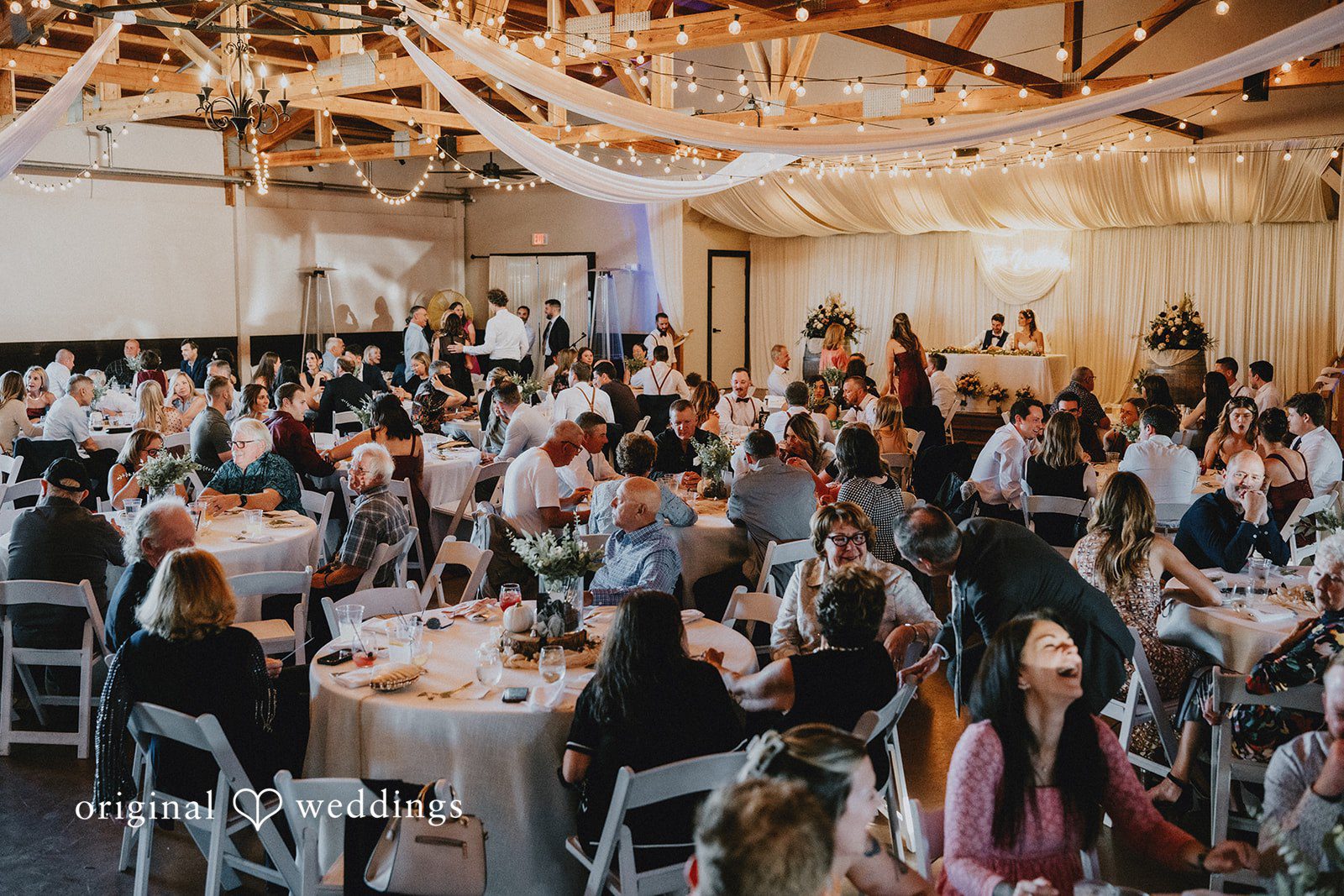 Guests filling the reception barn at Oak & Hood