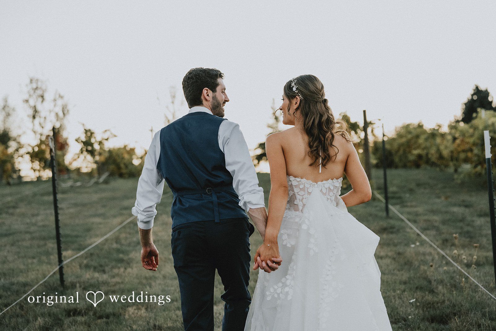 Couple walking hand in hand through the field