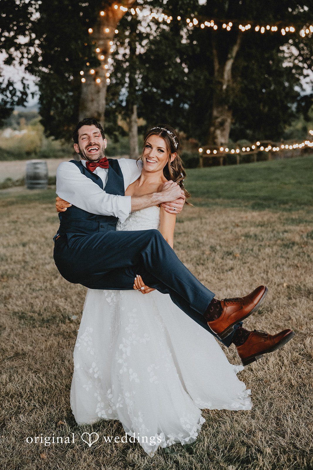 Groom sweeping the bride into his arms