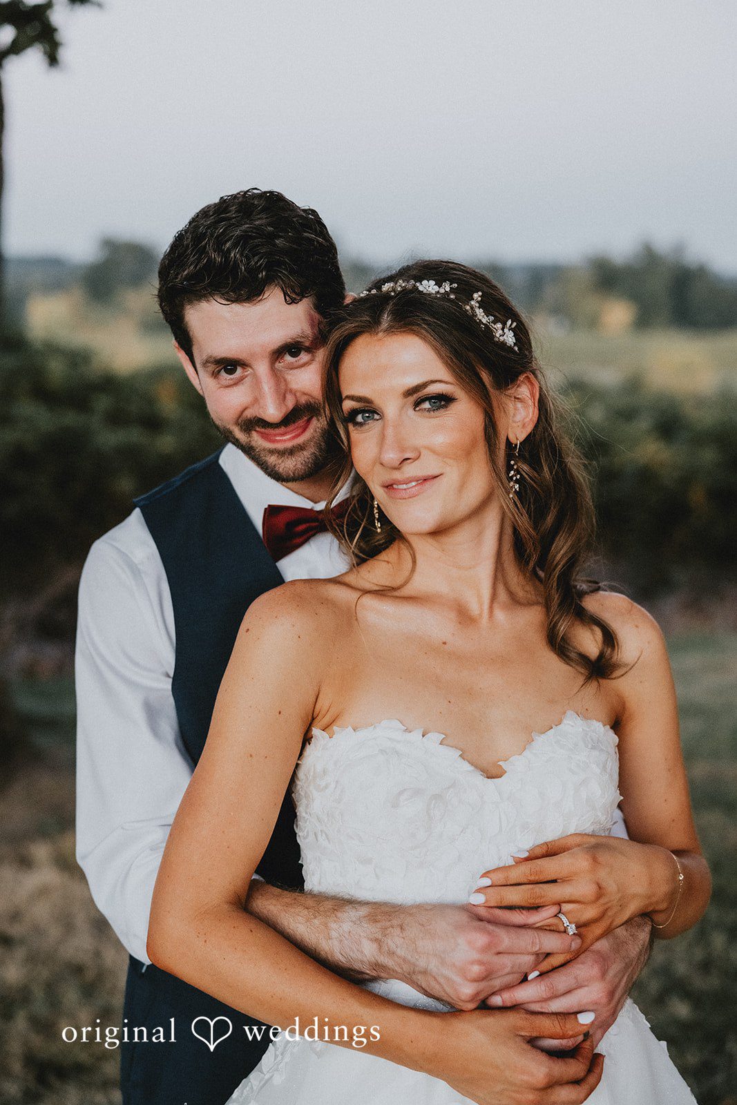 Groom hugging the bride from behind, captured by Portland wedding photographers from Original Weddings