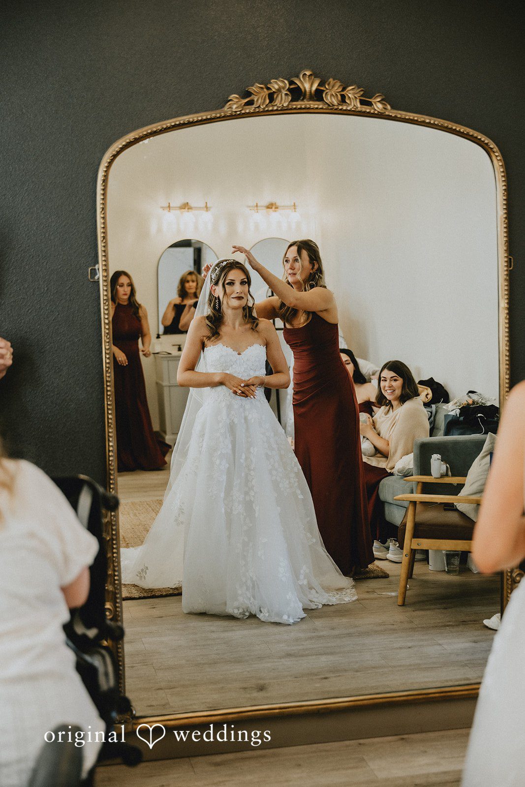 Bride checking her look in the doorway mirror