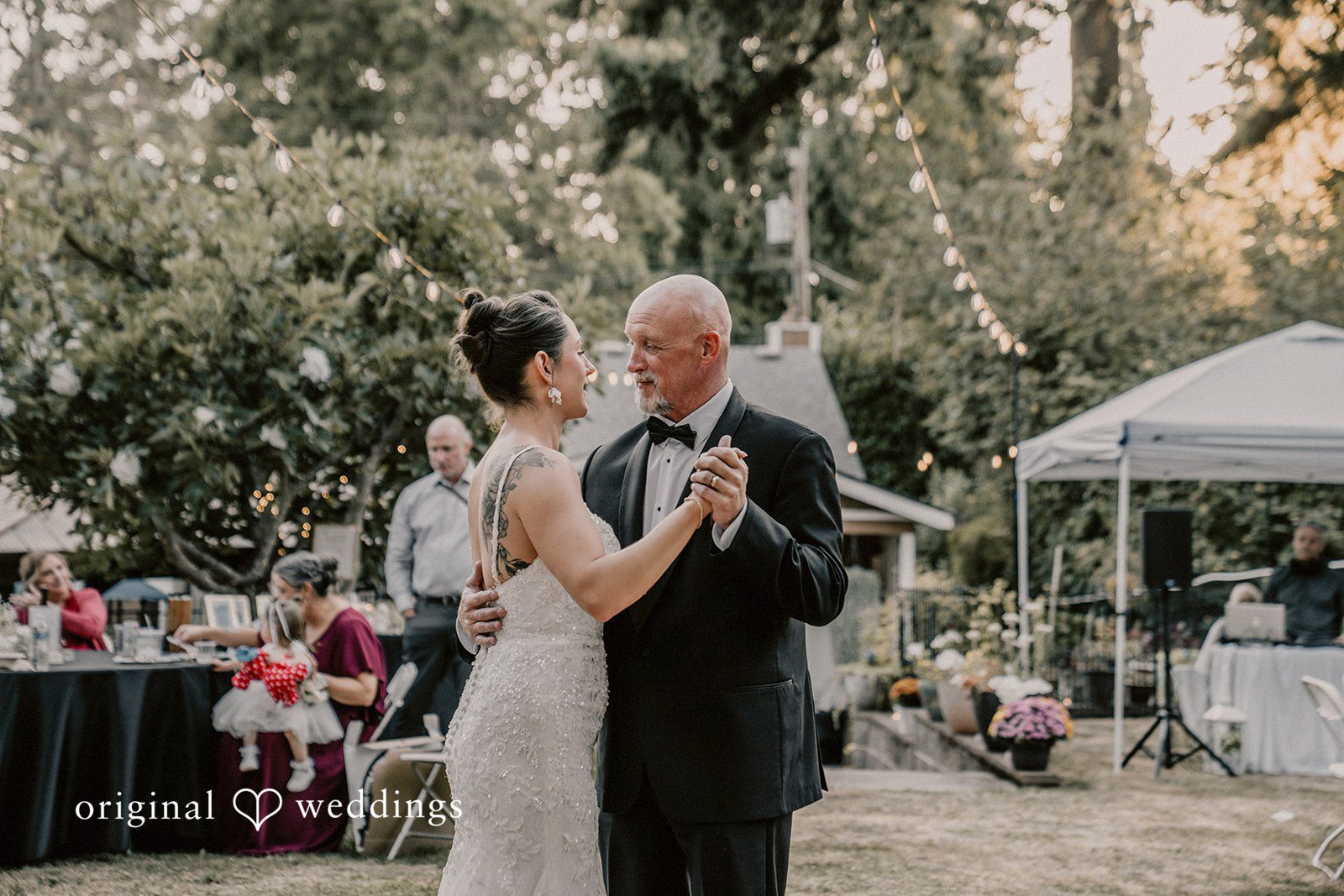 Ashley + Forrest A bride and man smile while dancing together at their reception.