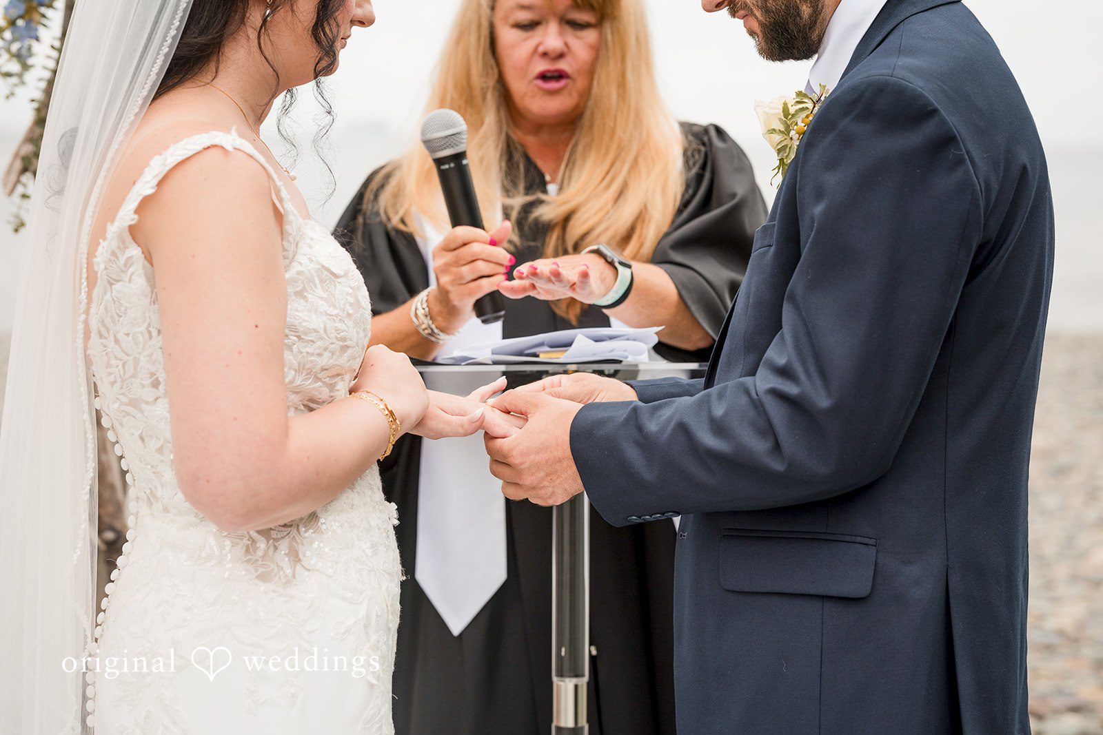 Francesca + Steven The groom puts a ring on the bride's finger