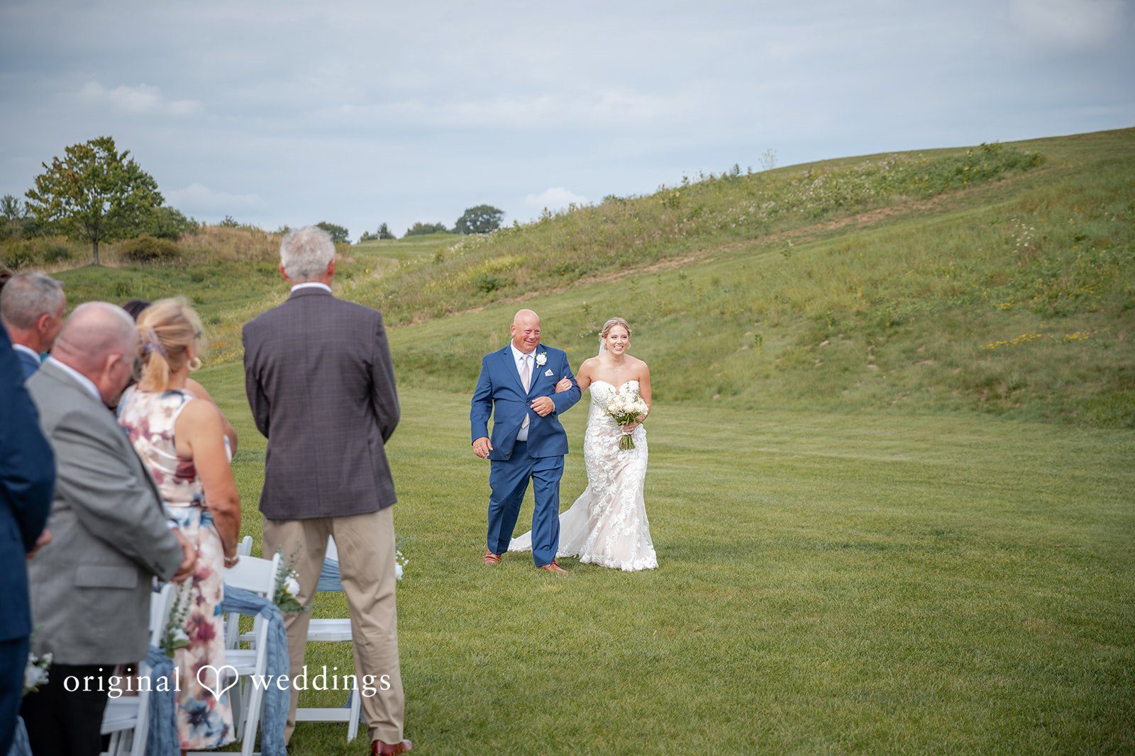 Taylor + Grady The bride's father escorts the bride down the aisle