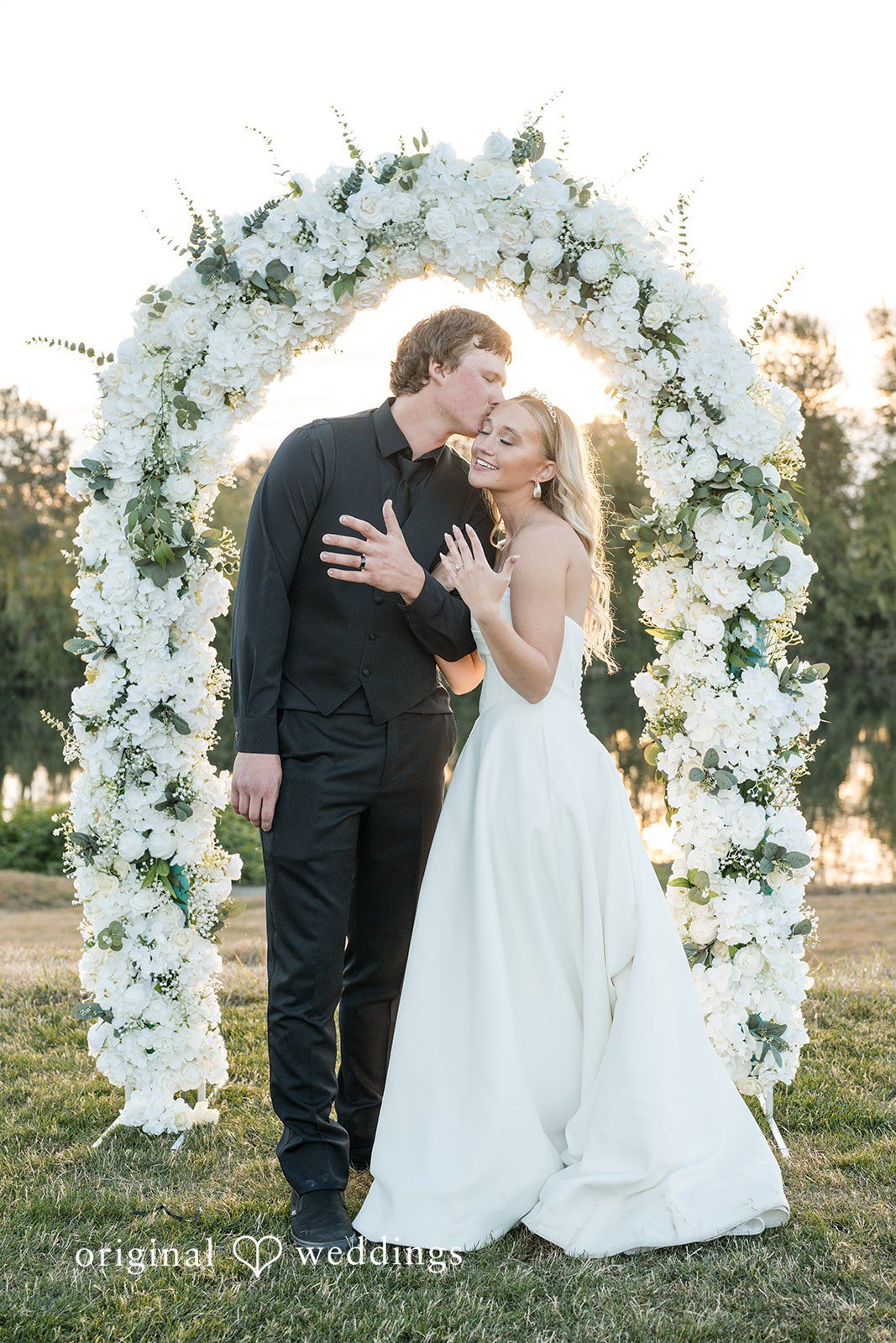Baylee + Jackson Couple under the floral arch at Pemberton Farm
