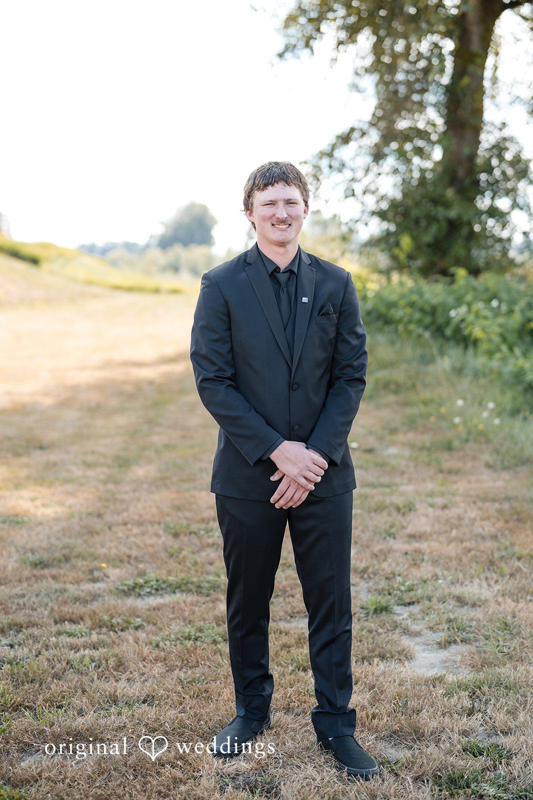 Baylee + Jackson Groom in a black suit