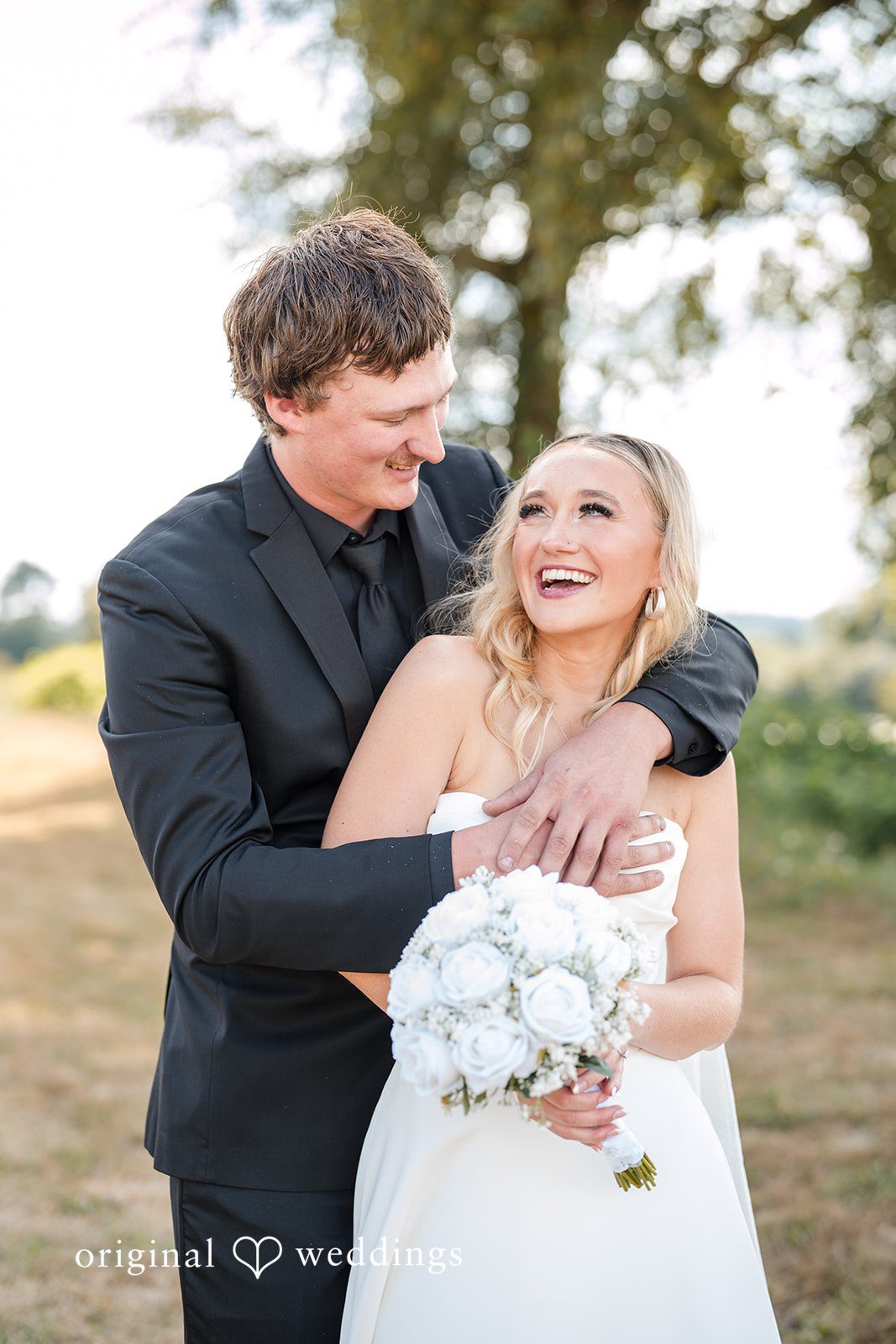 Baylee + Jackson Groom hugging the bride from behind