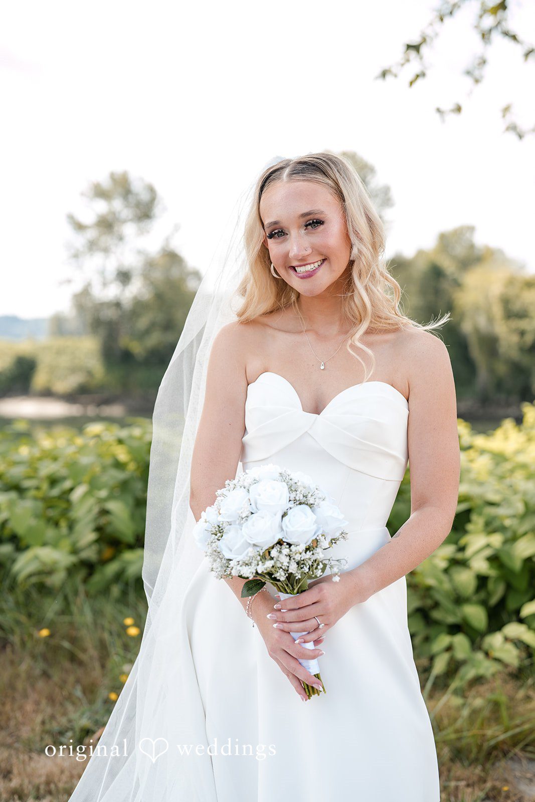 Baylee + Jackson Bride with her bouquet in the garden