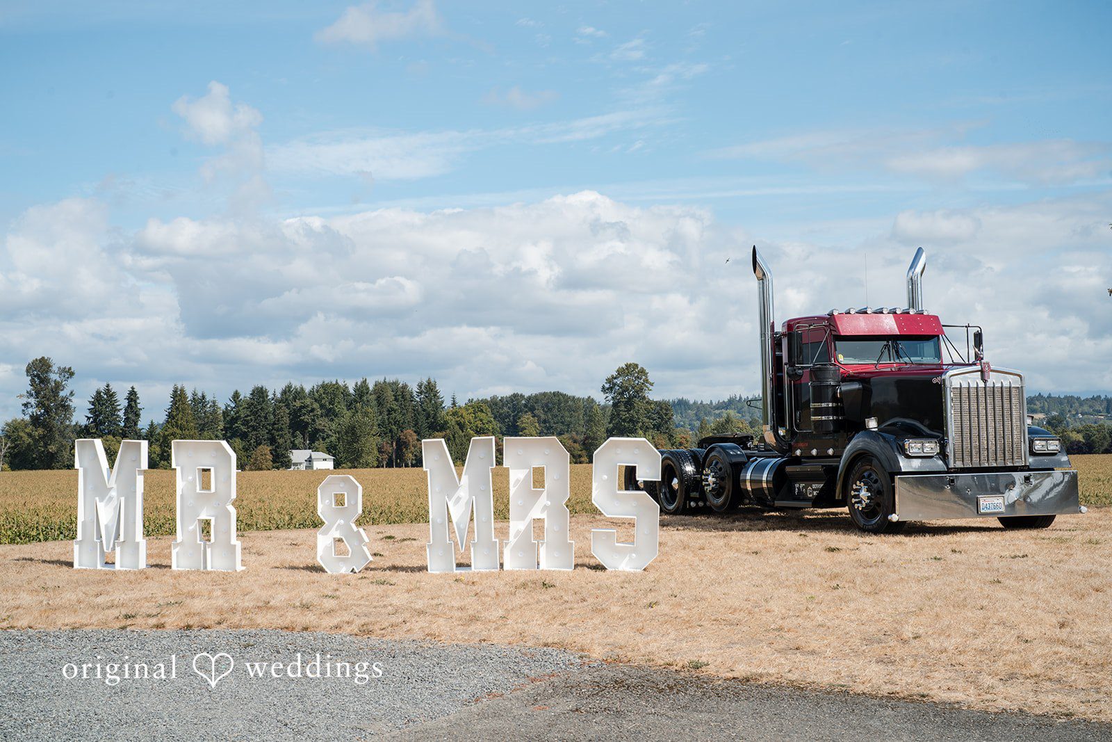 Baylee + Jackson Mr and Mrs sign beside a semi truck