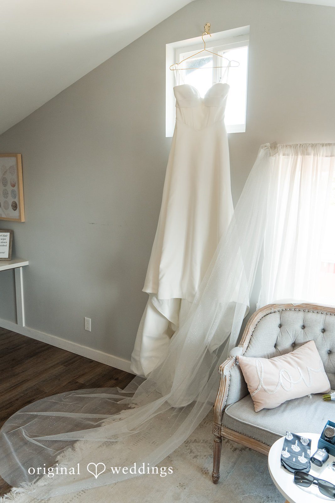 Baylee + Jackson Wedding dress hanging by a window