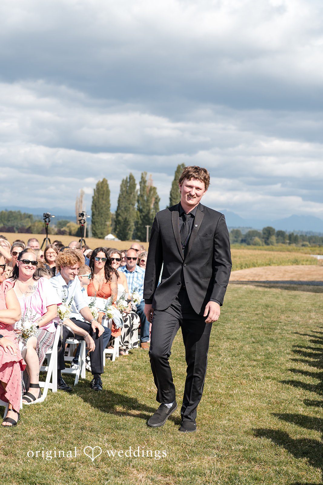Baylee + Jackson Groom walking past the guests at Pemberton Farm