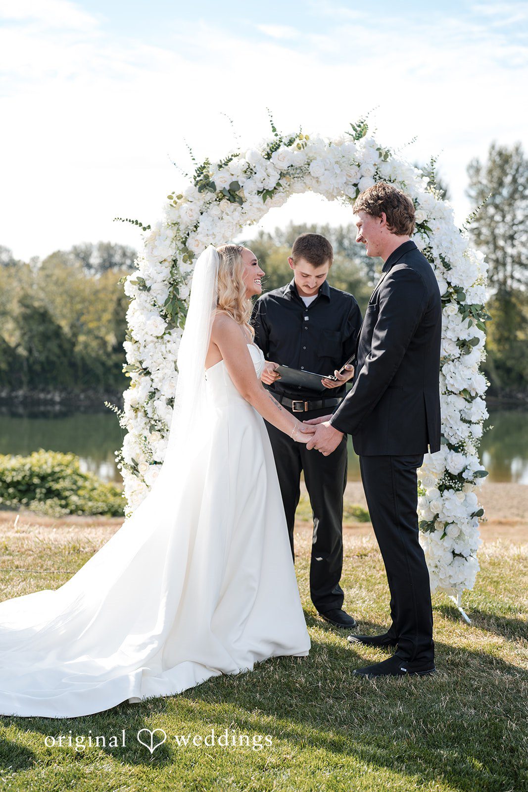 Baylee + Jackson Couple holding hands at the arch at Pemberton Farm