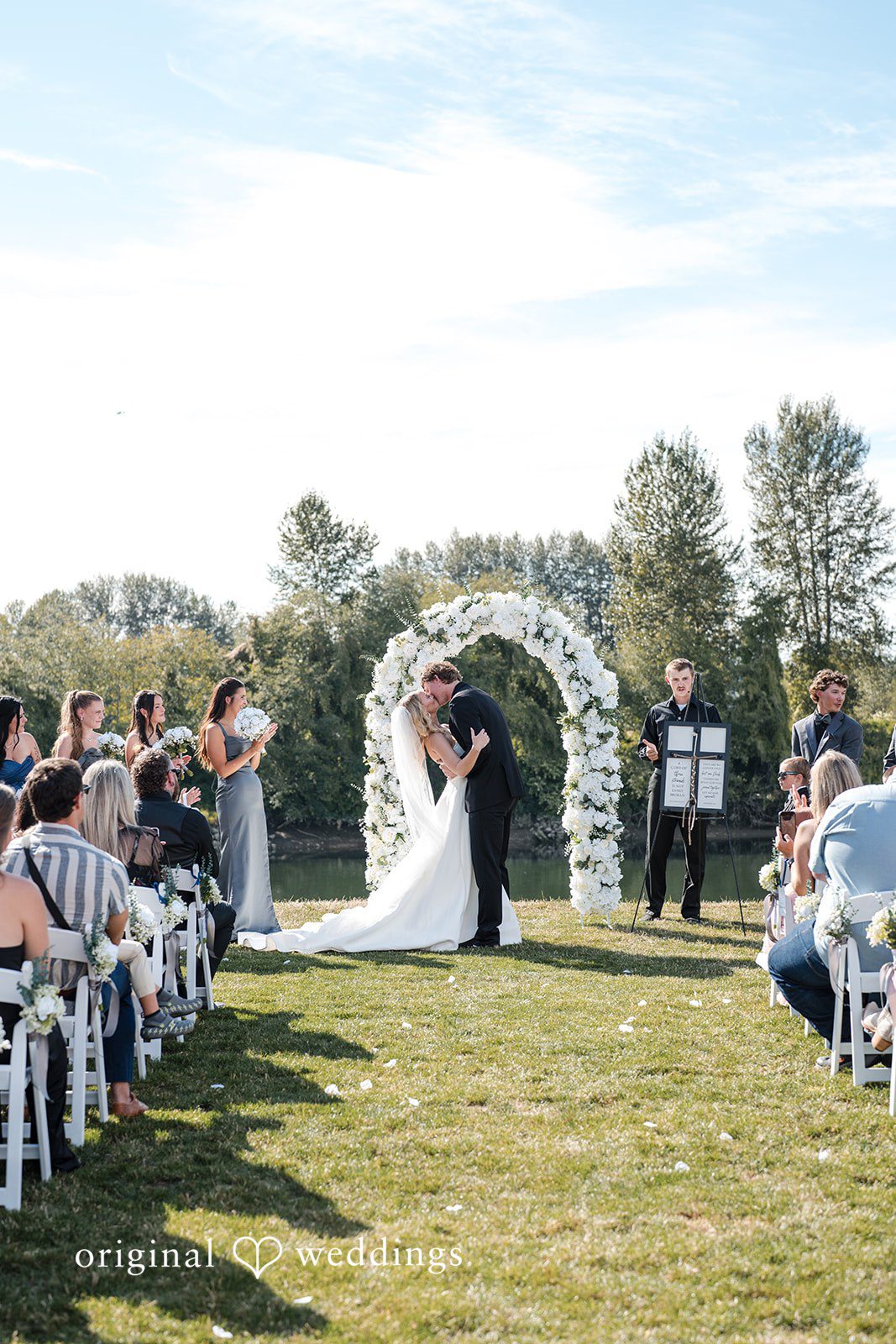 Baylee + Jackson Ceremony under a white floral arch
