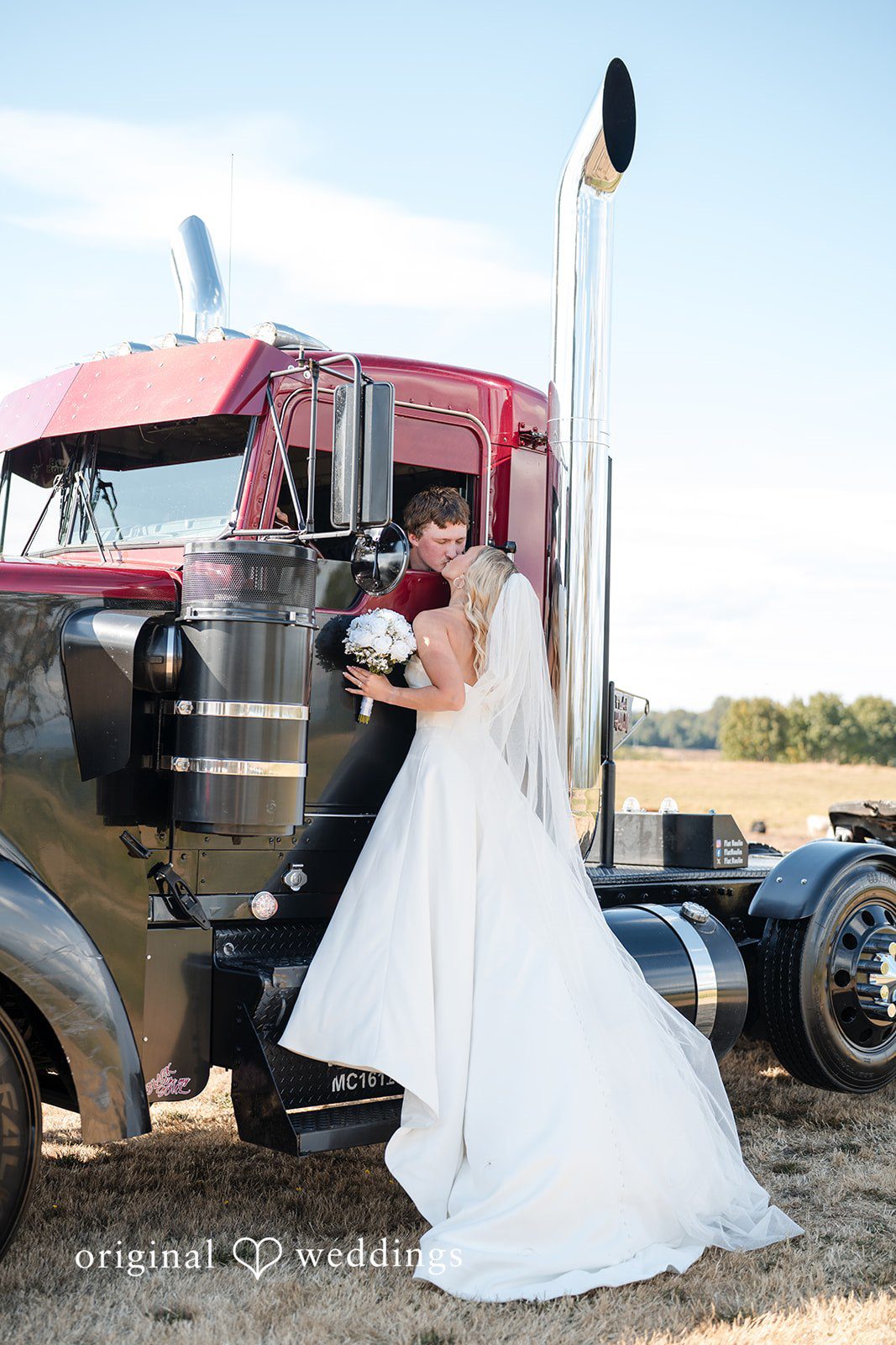 Baylee + Jackson Couple by a red semi truck at Pemberton Farm