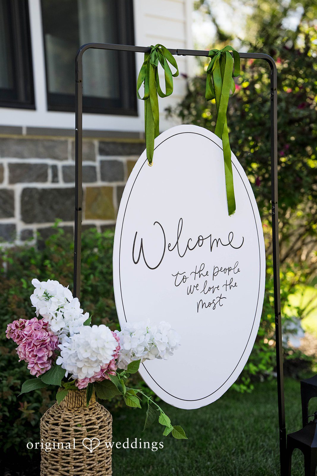 Brittany + Vincent Welcome sign with pink flowers by Philadelphia wedding photographers in a Pennsylvania backyard