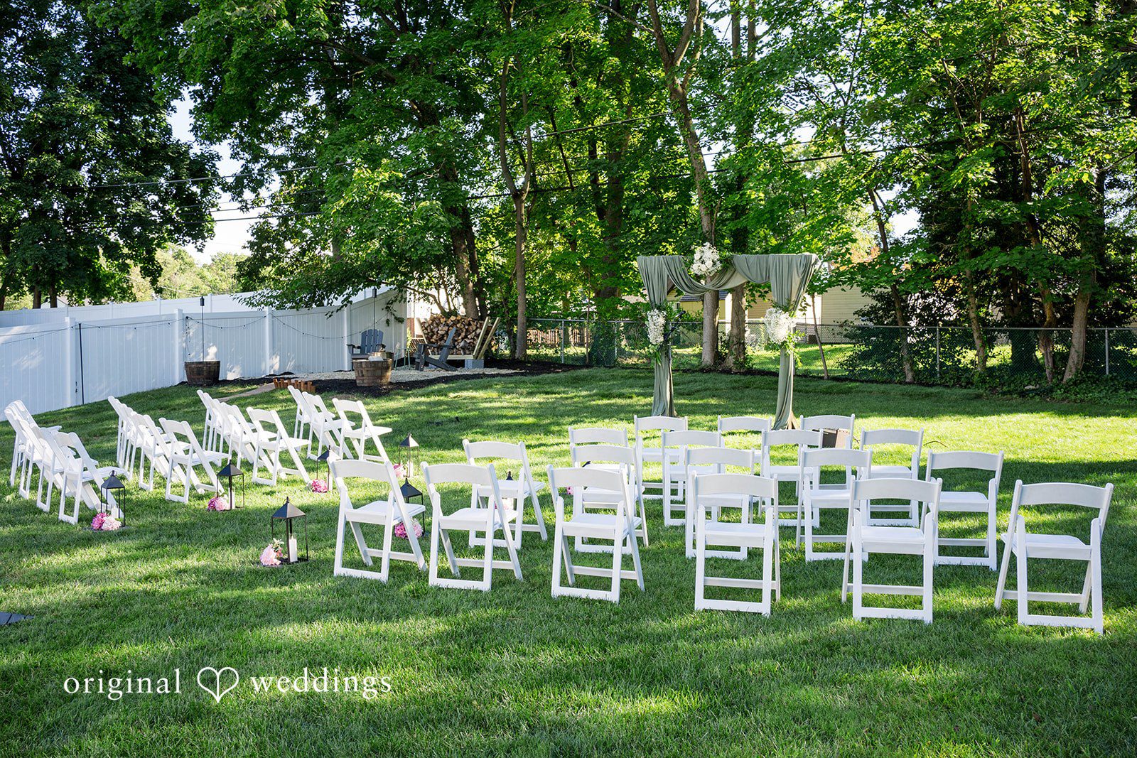 Brittany + Vincent Backyard ceremony set with white chairs in a Pennsylvania backyard