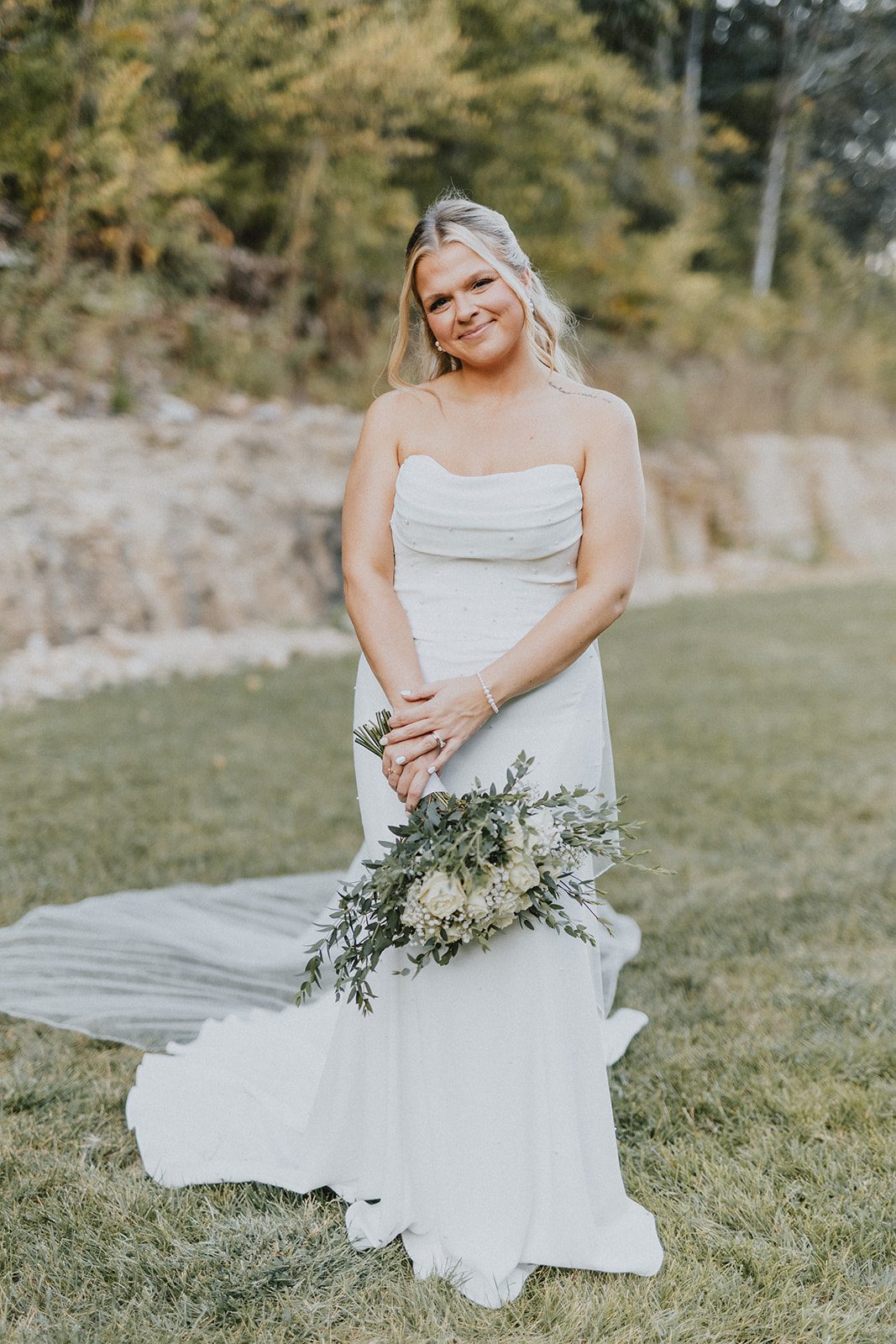 pine-hollow-farms-rustic-st-louis-natalie-john-p010-31 Bride holding her bouquet outdoors