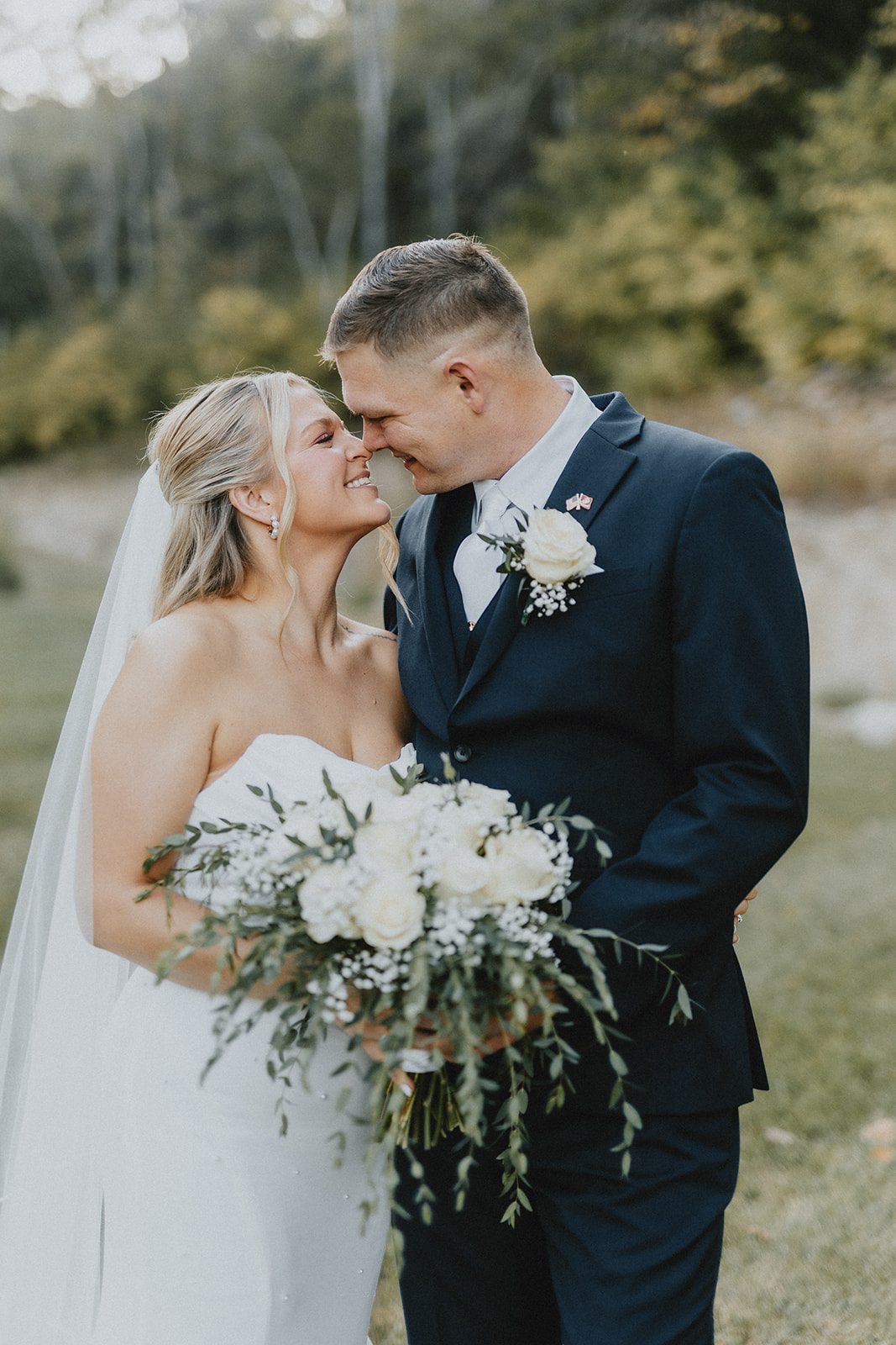 pine-hollow-farms-rustic-st-louis-natalie-john-p022-28 Groom kissing the bride on the cheek