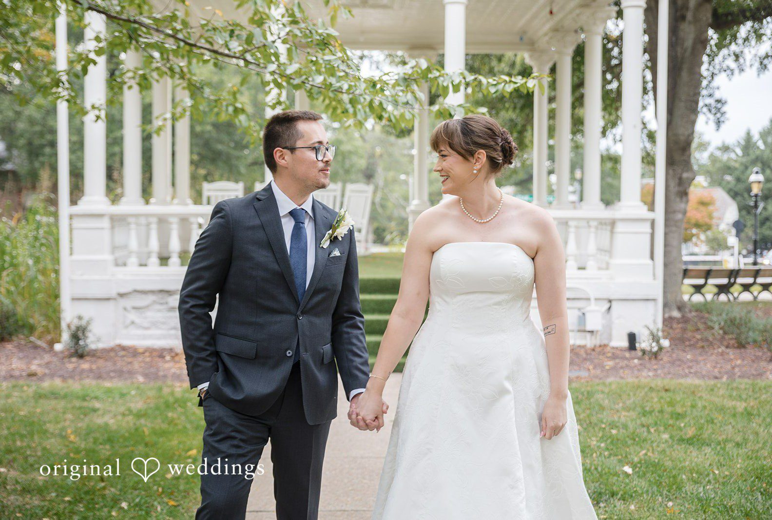 Hannah and Jonathan smiling together by the white gazebo, captured by Washington DC wedding photographers from Original Weddings at President Lincoln's Cottage