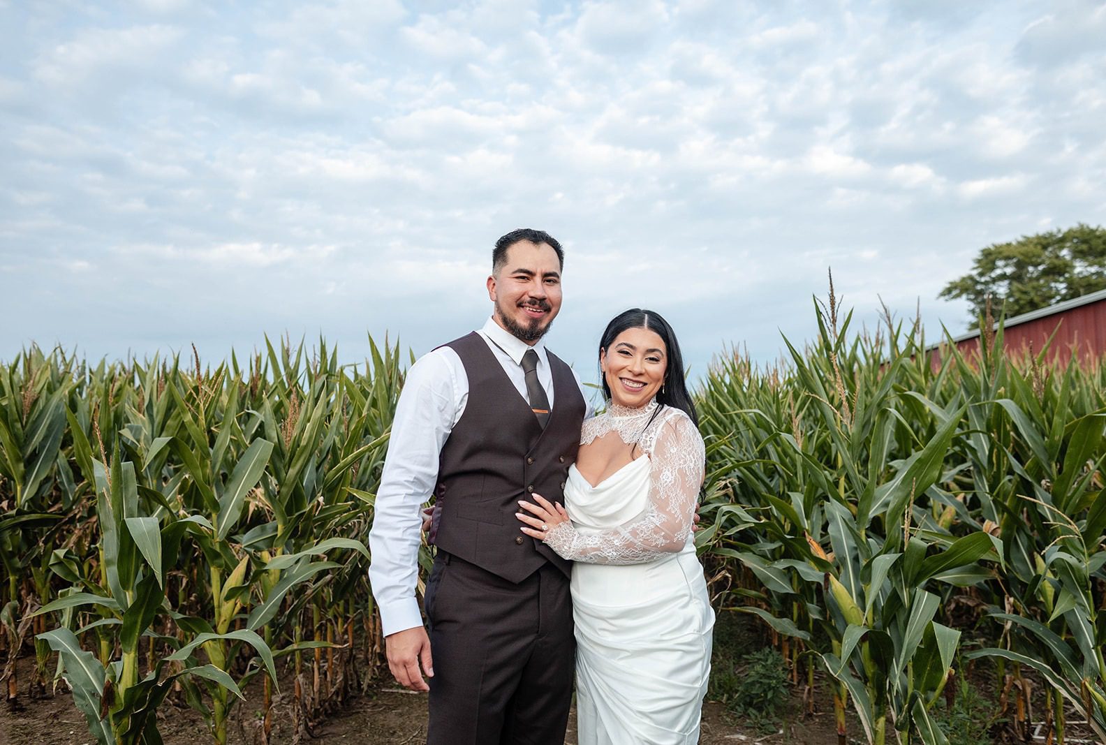Aaron and Yamileex smiling together in a cornfield, captured by Chicago wedding photographers from Original Weddings at their Illinois backyard wedding