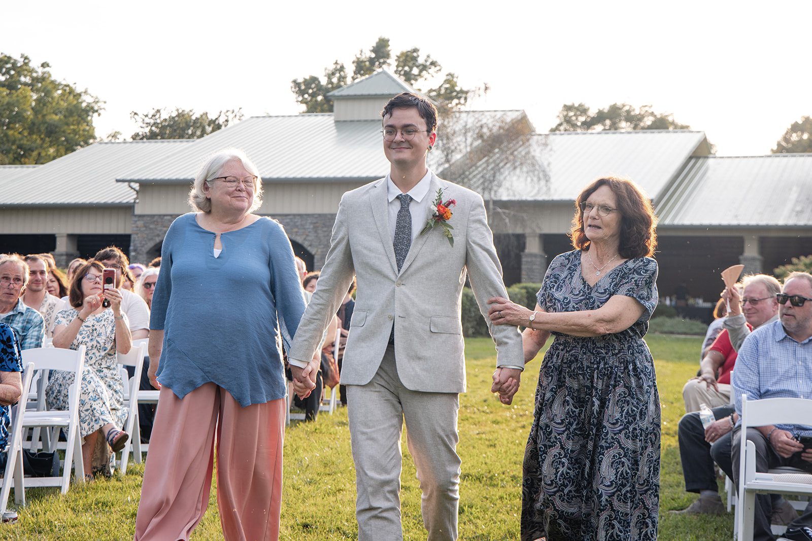 Groom walking down the aisle with family at Pyramid Hill