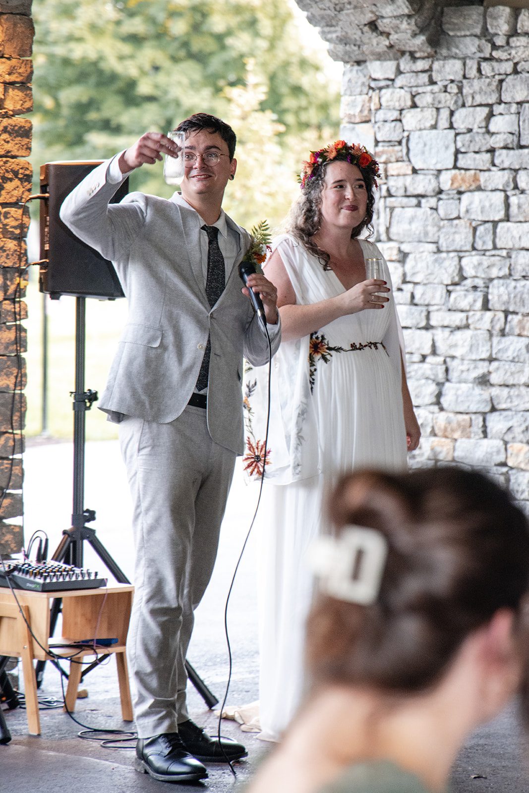 Bride and groom by the stone wall
