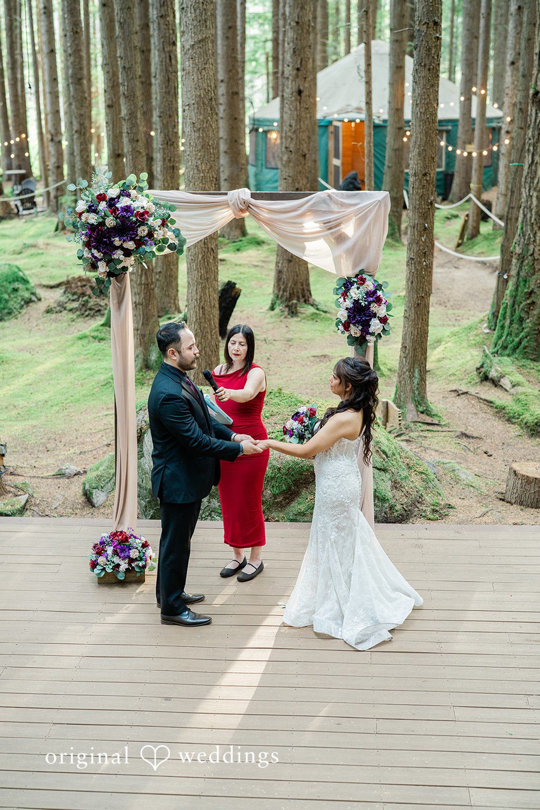 Christopher + Lydia Couple standing at the floral ceremony arch at Redmond Emerald Forest