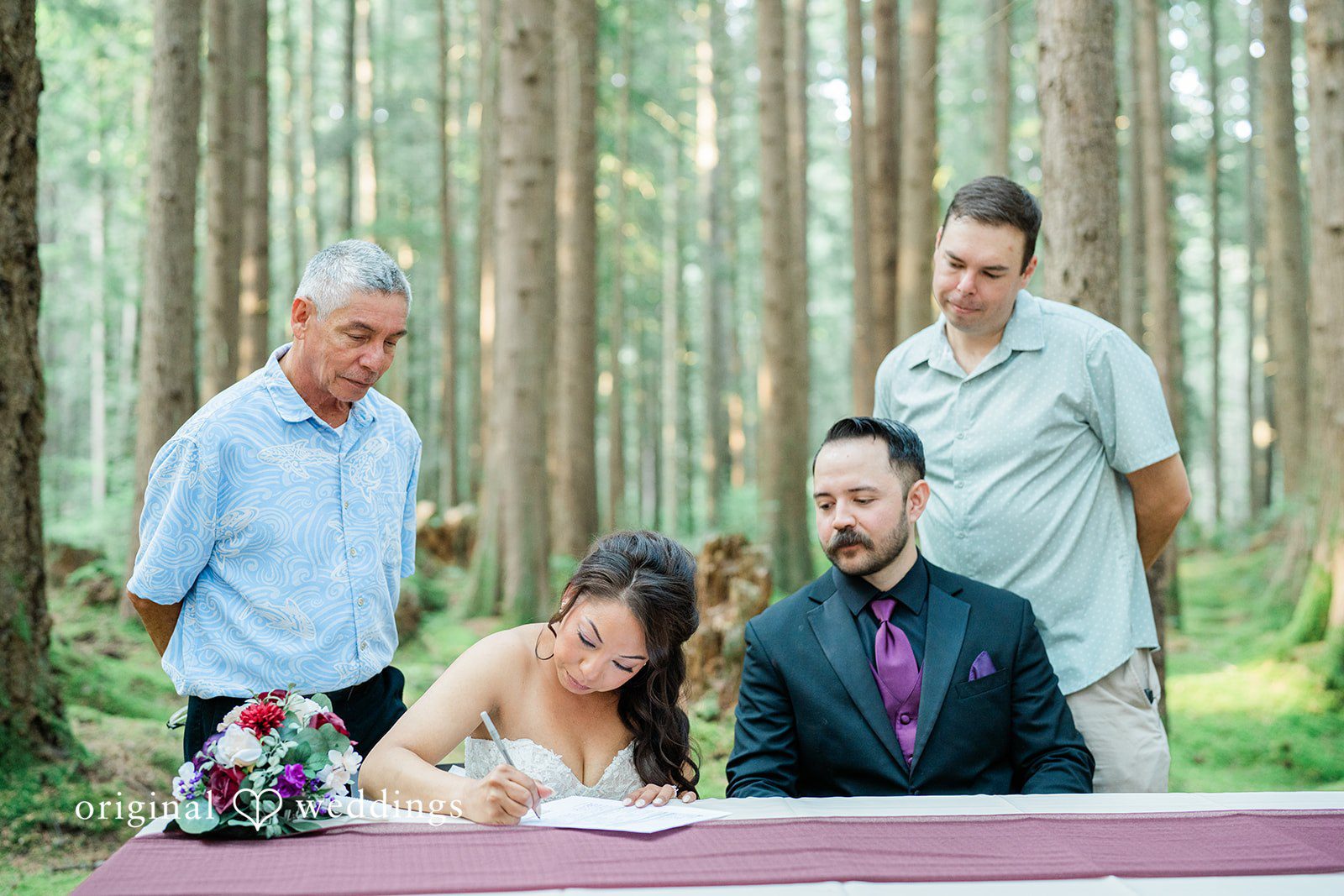 Christopher + Lydia Couple signing their marriage license with guests