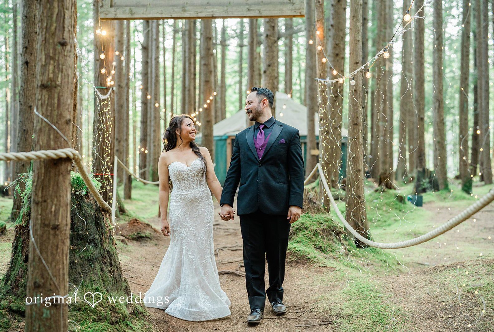 Couple walking together through the tall trees, captured by Seattle wedding photographers from Original Weddings at Redmond Emerald Forest