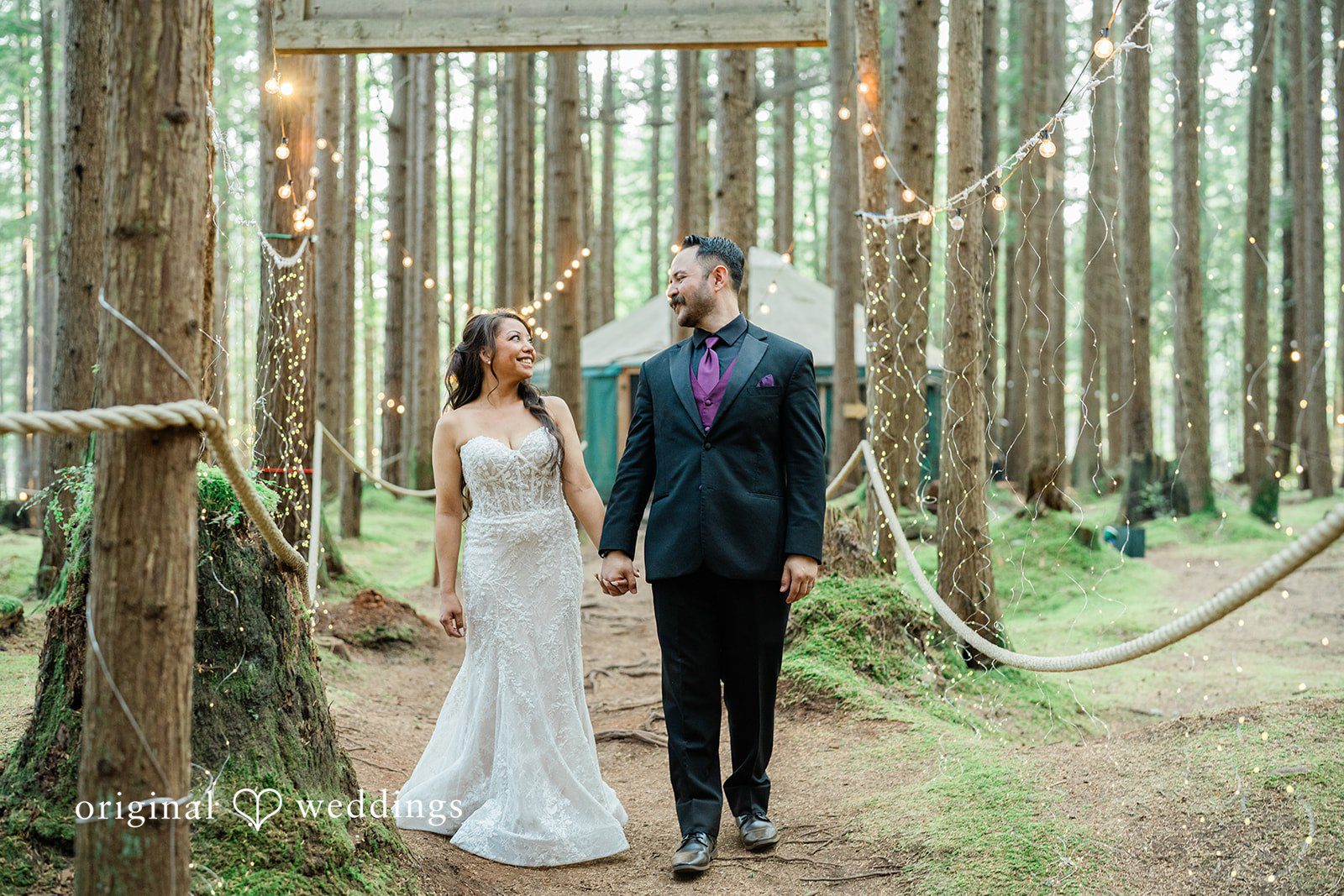 Christopher + Lydia Couple walking together through the tall trees, captured by Seattle wedding photographers from Original Weddings at Redmond Emerald Forest