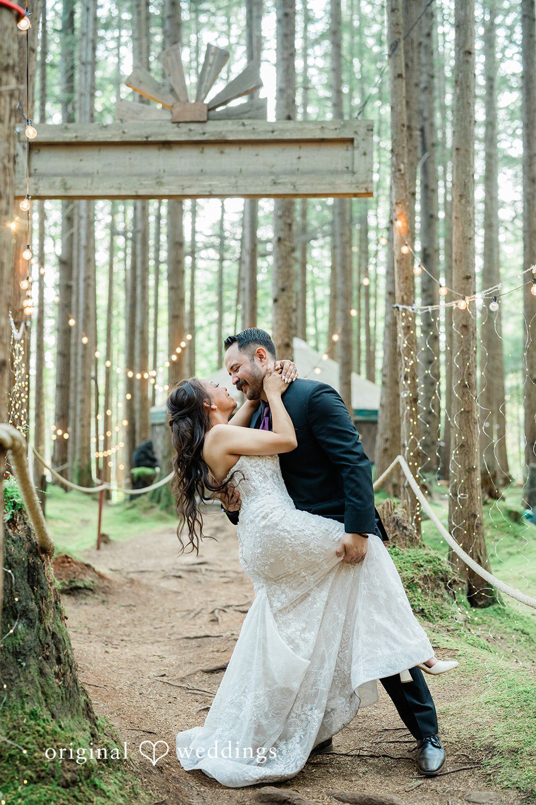 Christopher + Lydia Couple sharing a dip kiss among the evergreens at Redmond Emerald Forest