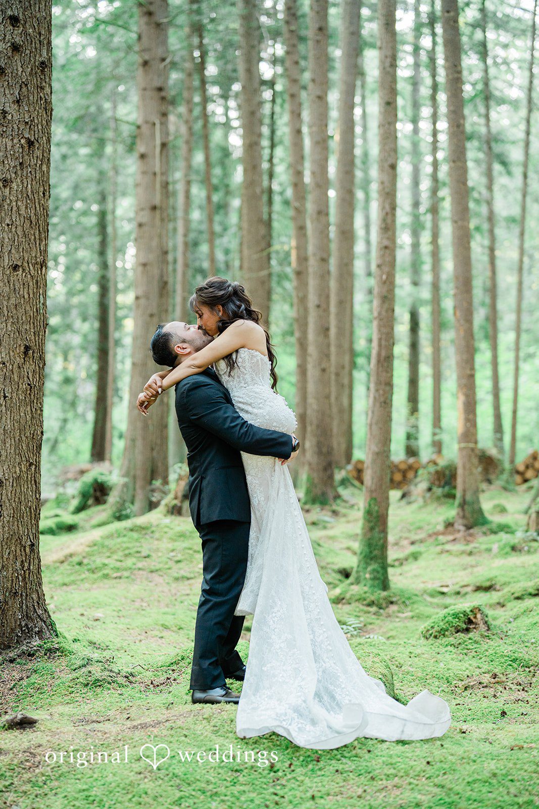Christopher + Lydia Couple sharing a kiss in the woods