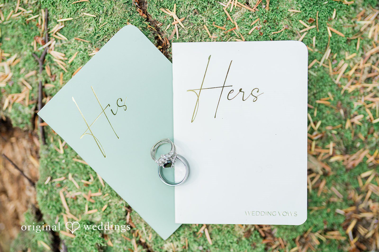 Christopher + Lydia Wedding rings resting on vow books in the moss