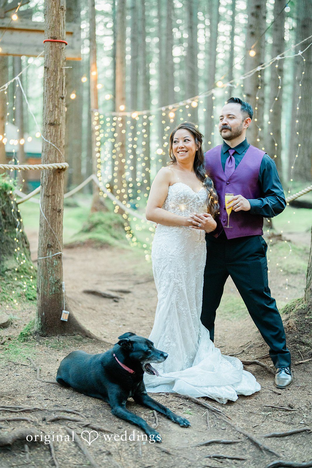 Christopher + Lydia Couple posing with their dog in the forest