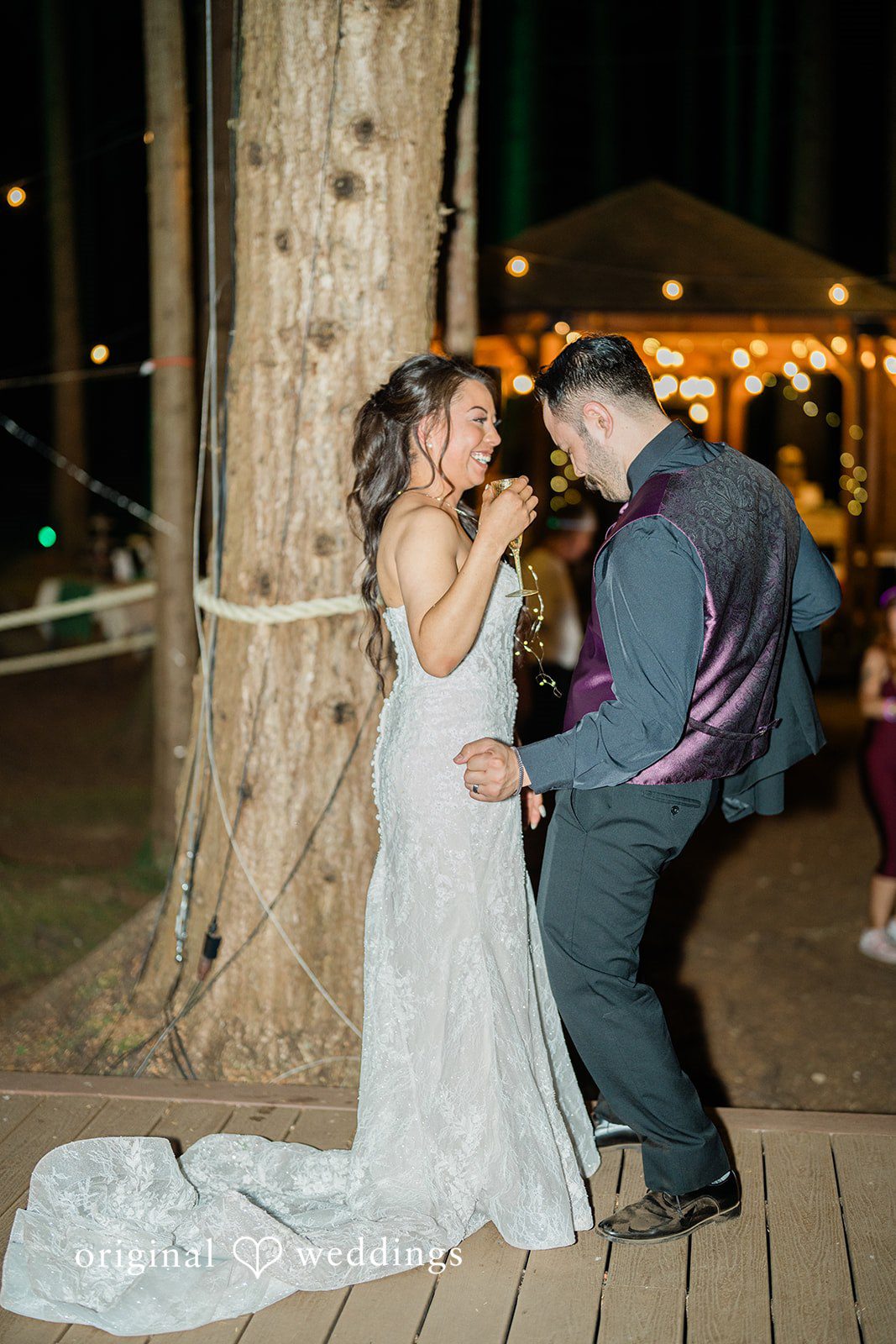 Christopher + Lydia Couple under twinkle lights at the reception