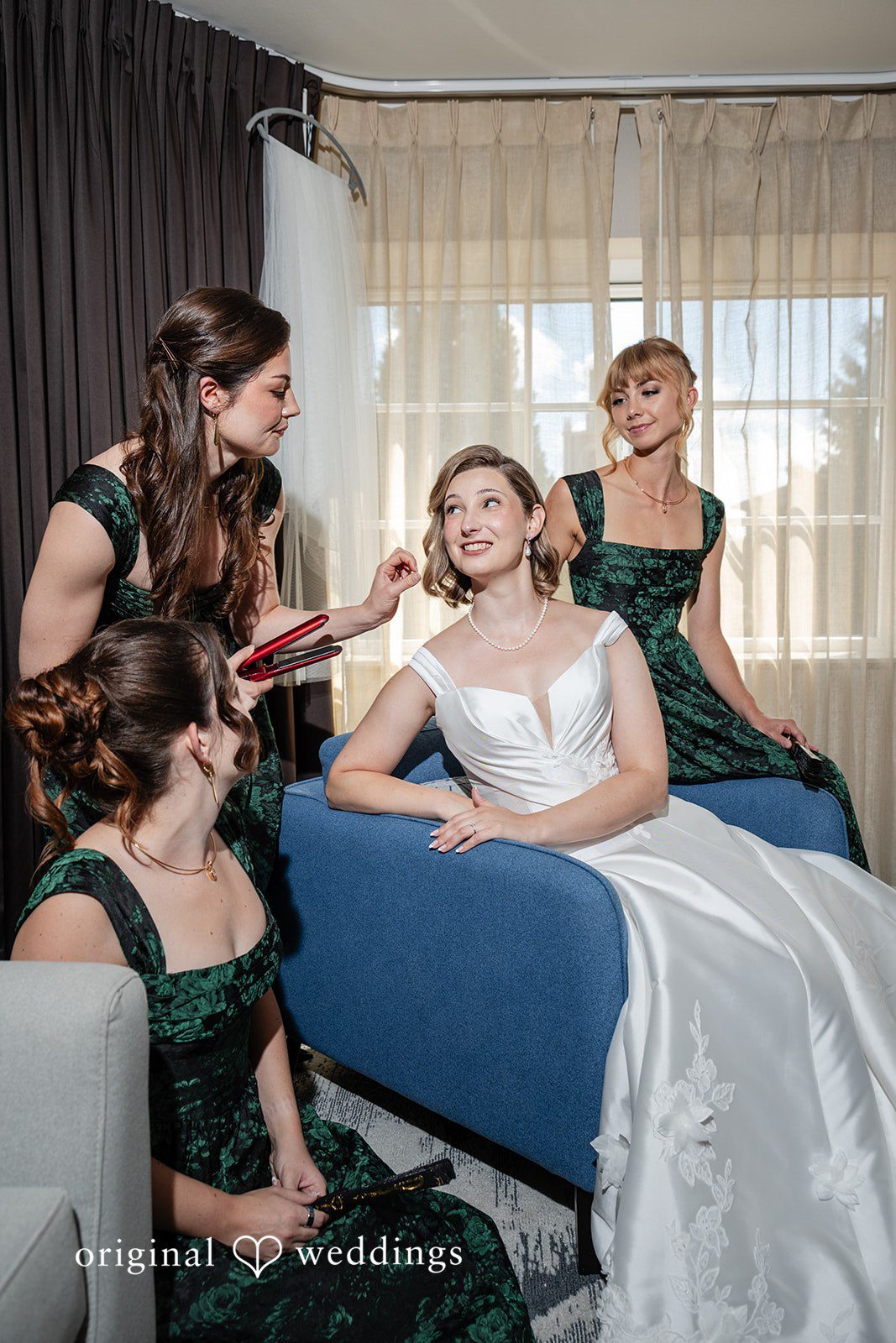 Bride getting ready with bridesmaids on the sofa at Reverie Ballroom