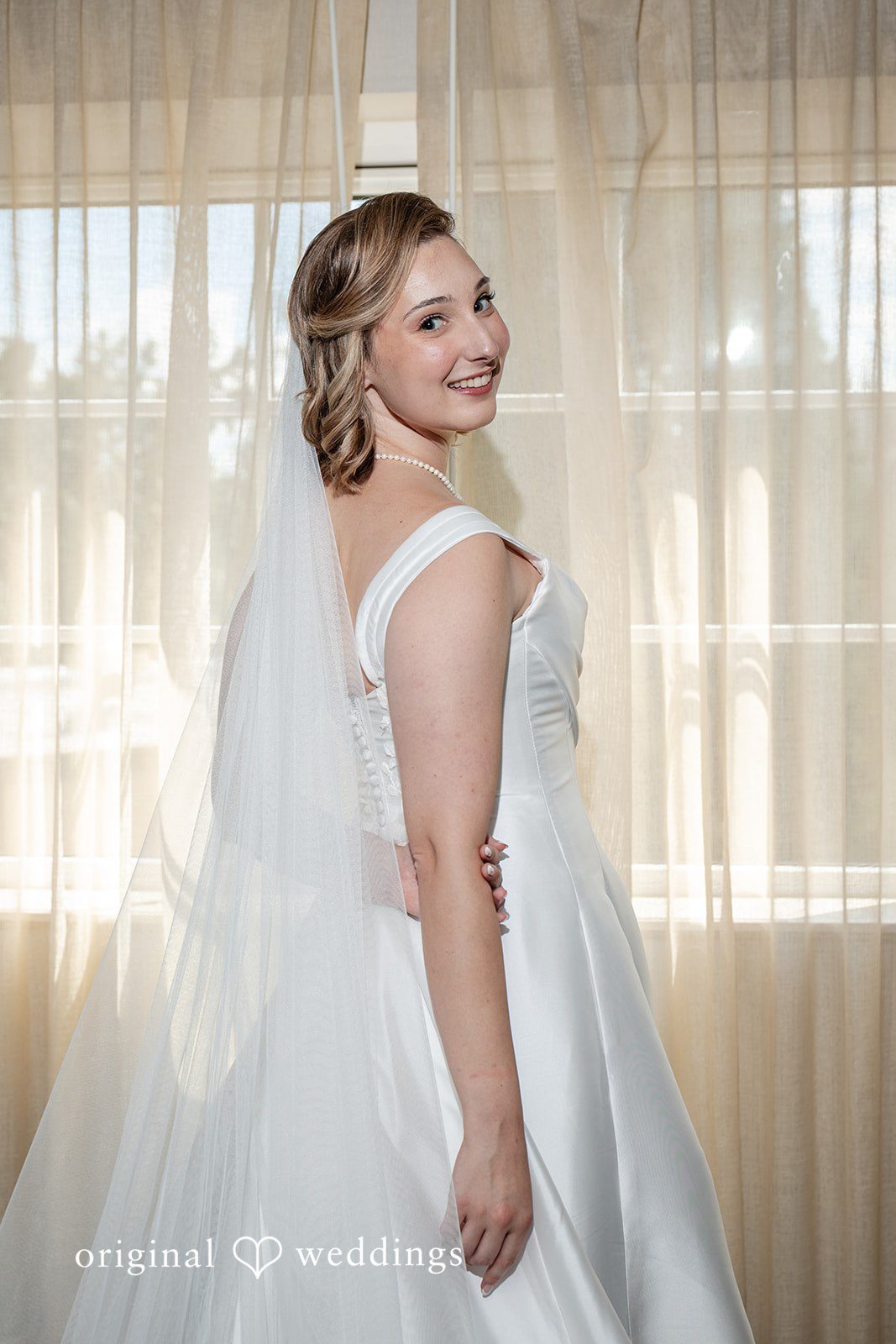 Smiling bride portrait in natural window light