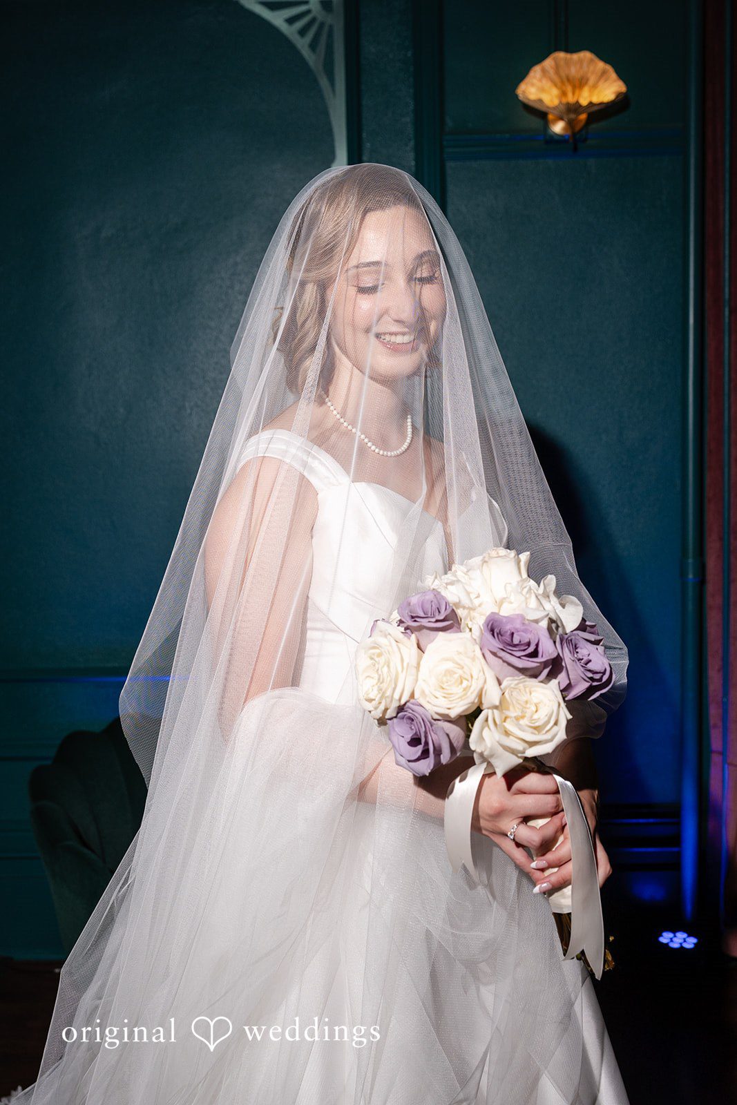 Bride in her veil holding her bouquet at Reverie Ballroom
