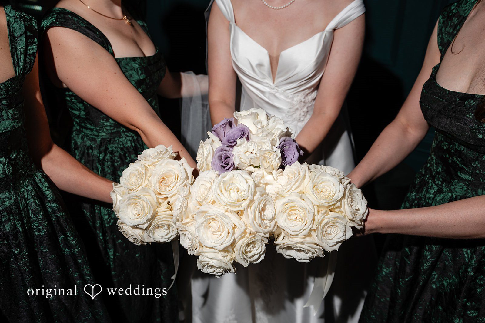 Bride with her bridesmaids holding white bouquets